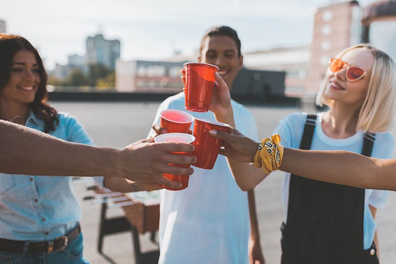 group of friends holding red cups