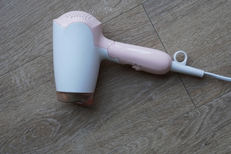 hair dryer on wooden floor