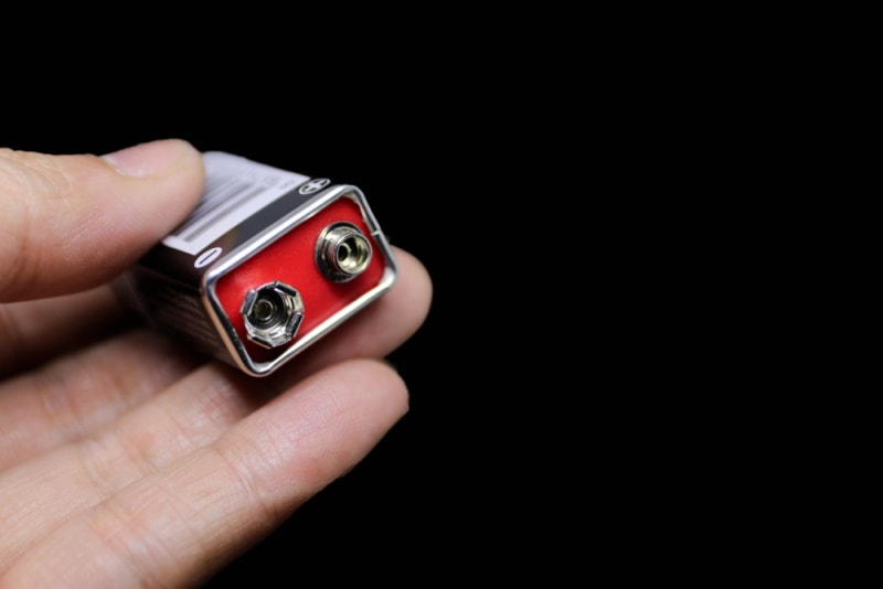 hand holding 9 volt battery