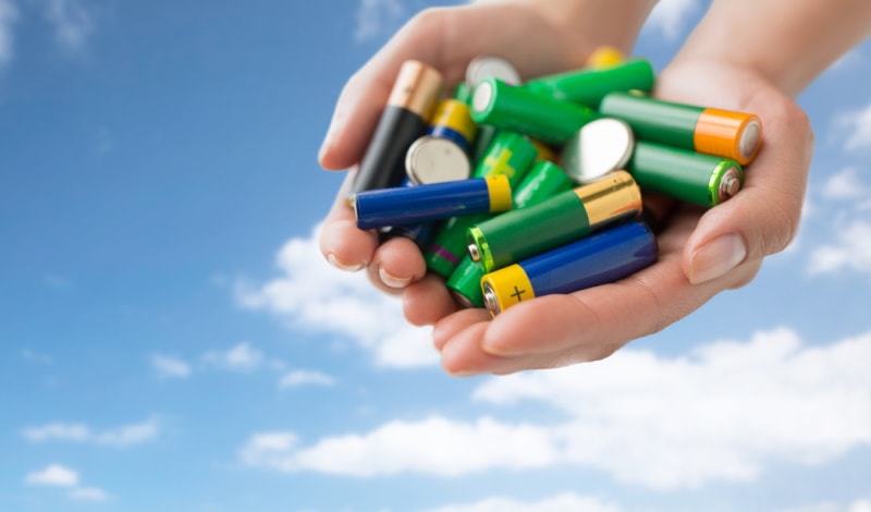 hands holding different types of batteries