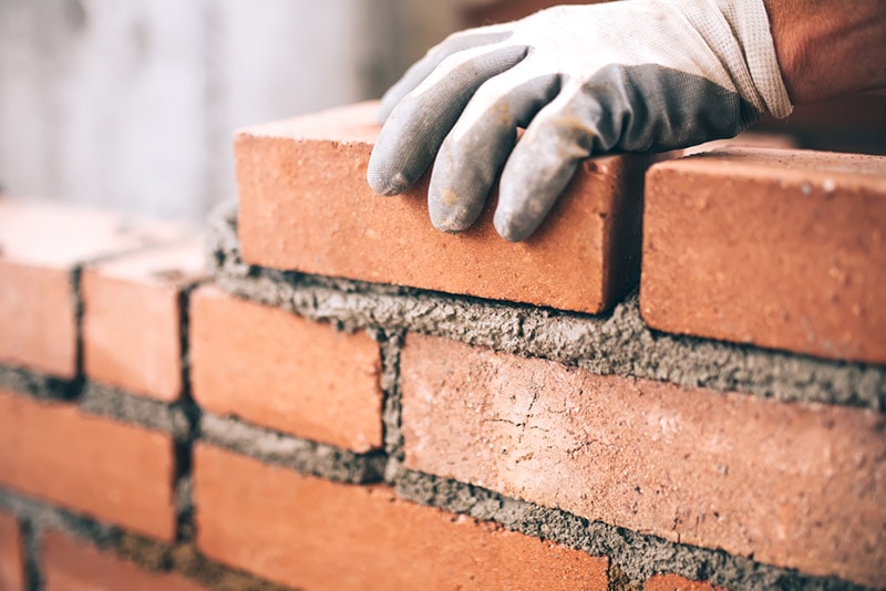 installing bricks with mortar