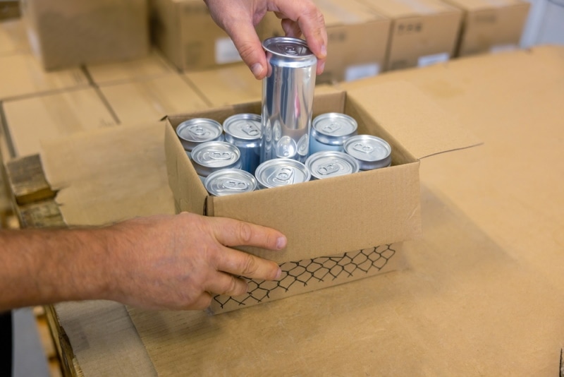 man taking out beverage from box