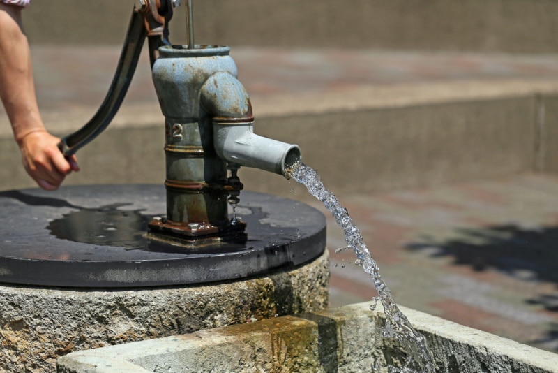 man using hand pump