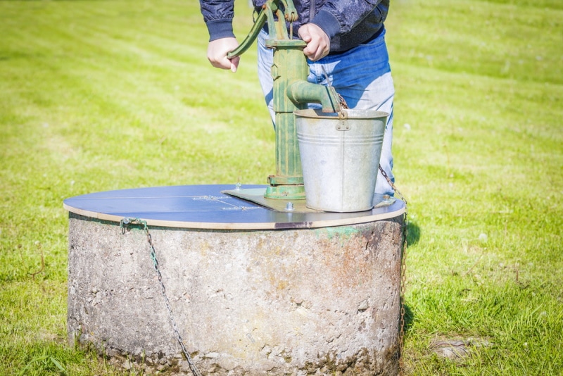 man using well pump