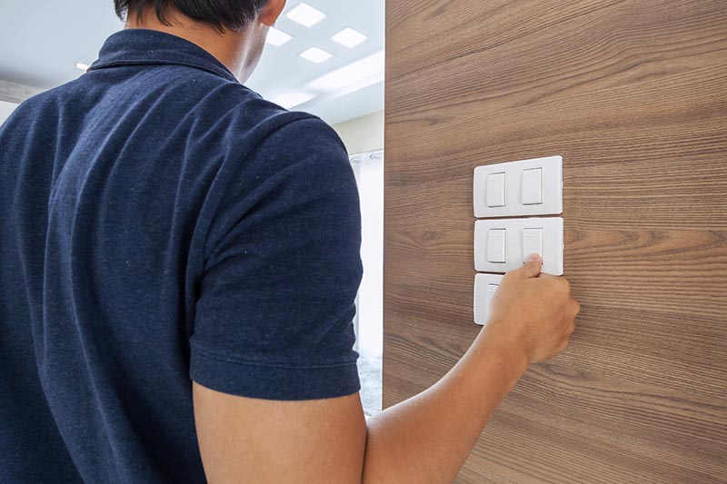 man switching off the light