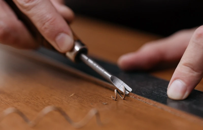 person carving wood