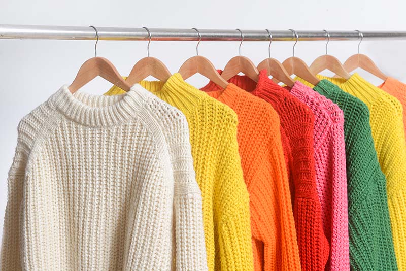 row of different colorful knitted sweater