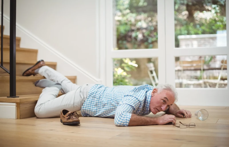 senior man falls down the stairs at home