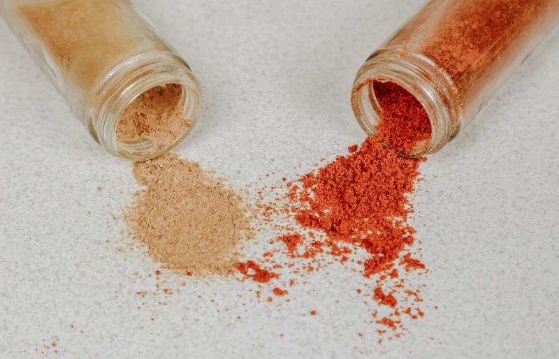 spice jars with cayenne and chili pepper powders