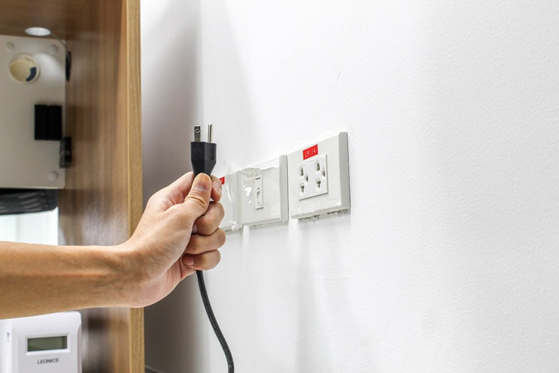 unplugging cord from the outlet