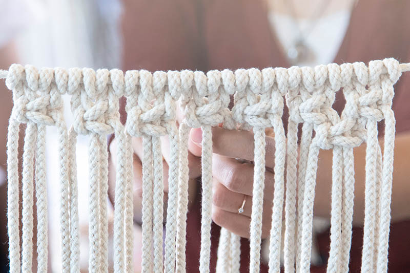woman knitting handmade macrame