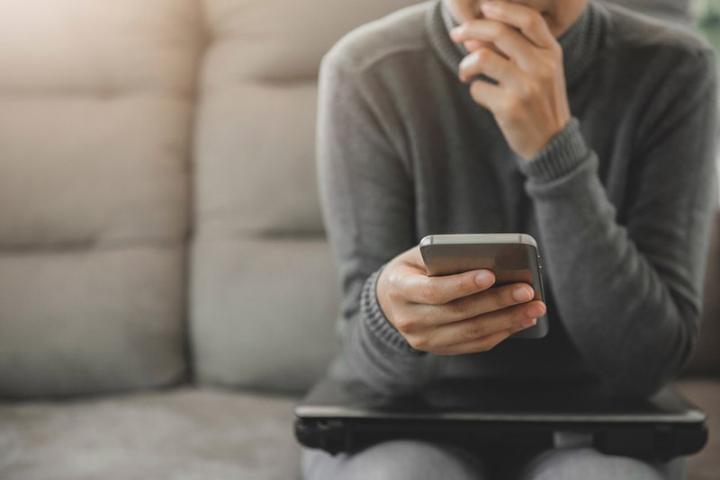 woman looking the phone worried