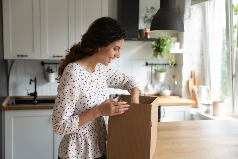 woman opening box in the kitchen