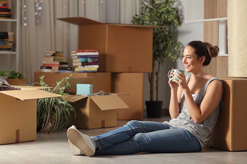 woman tenant drinking coffee after moving her items