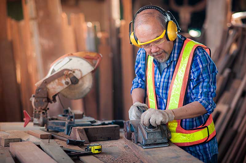 worker wearing ear protection plugs