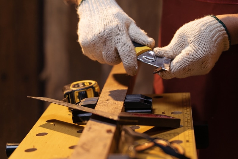 Carpenter sharpening a pencil