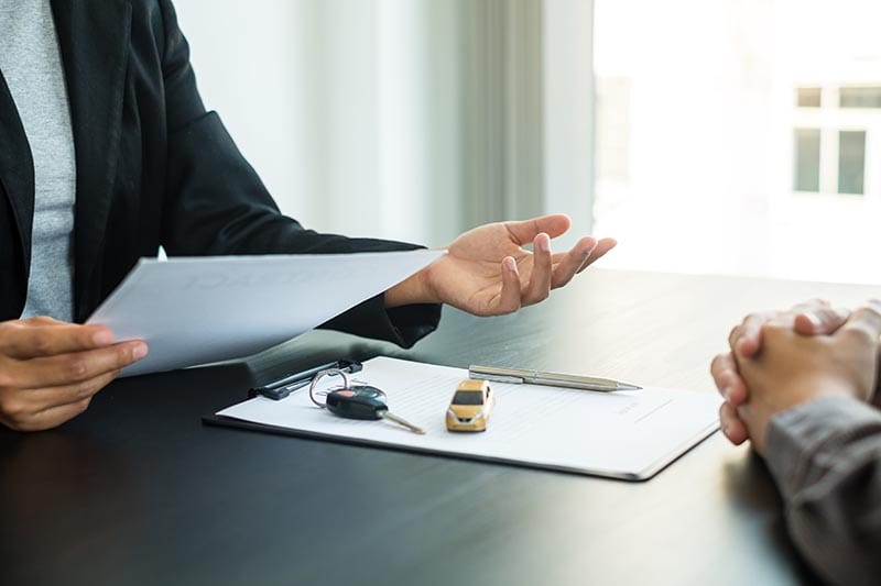 car dealer provides advice on loans and insurance