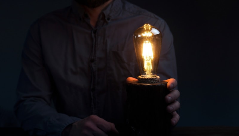 man holding table lamp