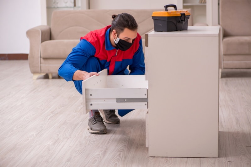 man pulling out drawer