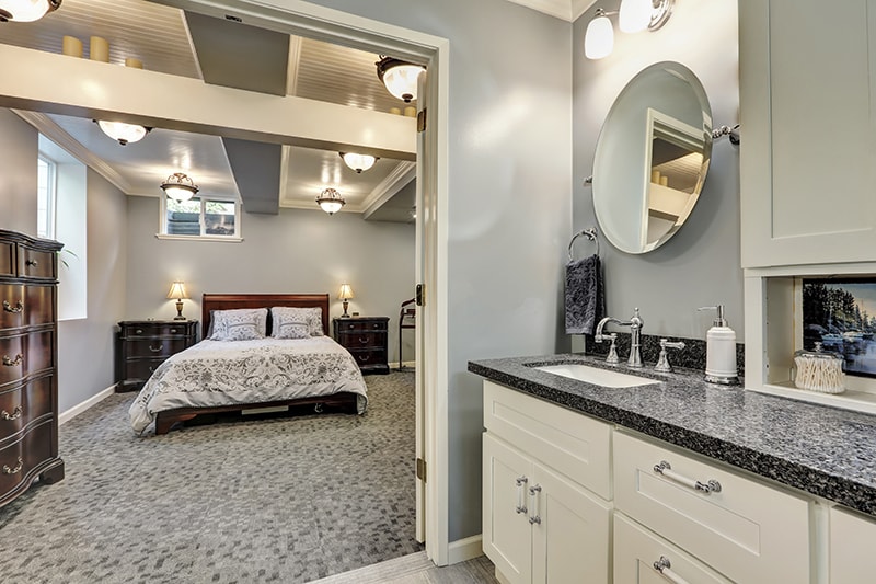 Basement bathroom interior in gray and white tones
