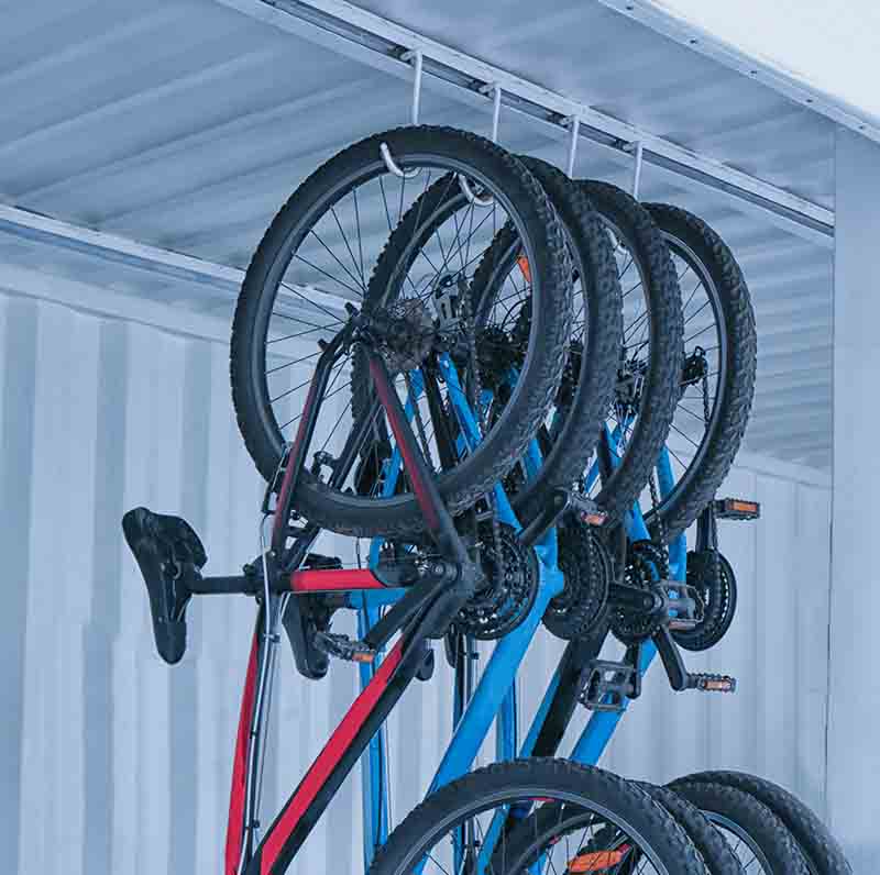 Bicycles hanging on rack under ceiling