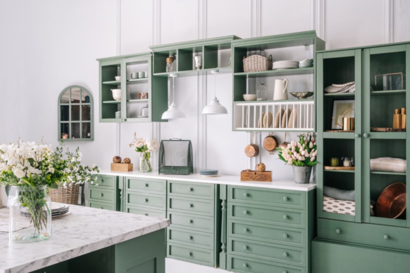 Big white kitchen with green furniture
