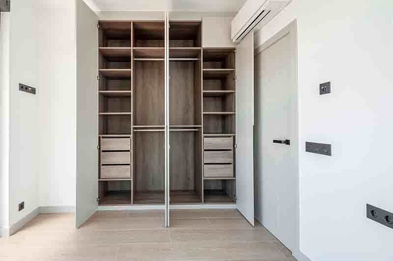 Built-in empty wardrobes with open doors