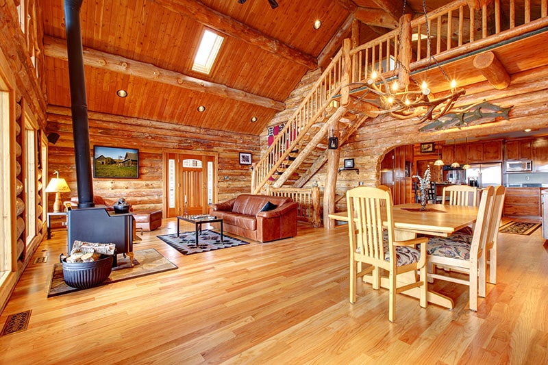 Large luxury log house living room with staircase.