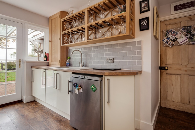 Luxury stylish kitchenette with wine glass storage and refrigerator interior
