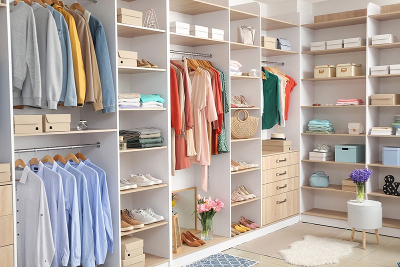 Modern wardrobe with stylish spring clothes and accessories