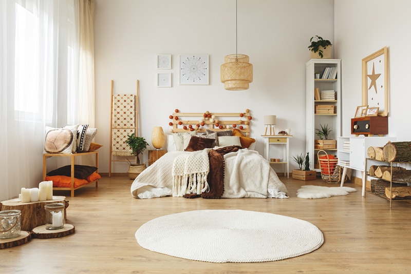 Round white rug on the floor in bright bedroom Interior Design
