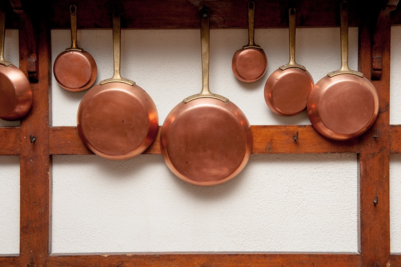 Row of vintage copper pans