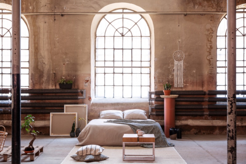Table on rug in spacious bedroom interior