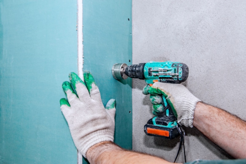 Using a keyhole saw on drywall