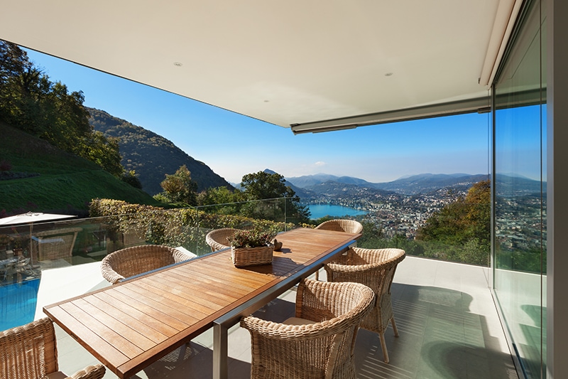 beautiful veranda with wooden table and wicker chairs