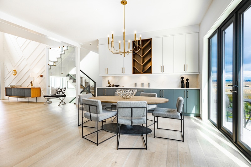contemporary living room with open concept view through to dining room kitchen and a marble fireplace with gas fire interior design
