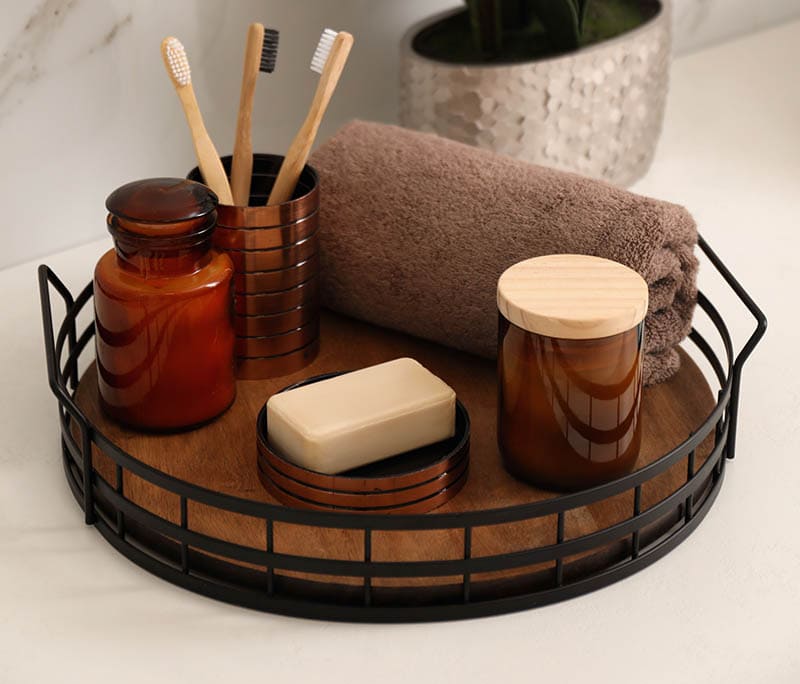 Beautiful flowers and different toiletries on countertop in bathroom