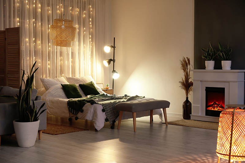 Interior of stylish bedroom with modern lamp