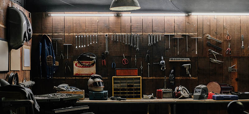 Old tools hanging on wall in workshop