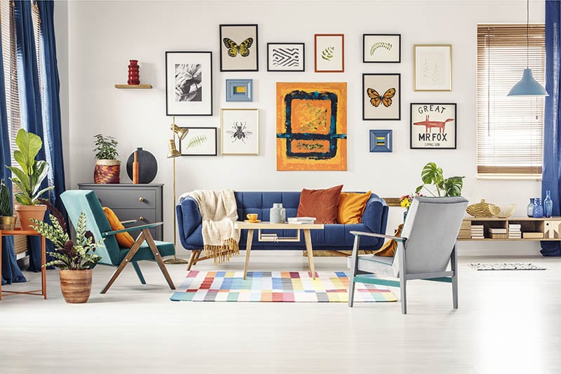 Simple posters gallery hanging on the wall in bright living room interior