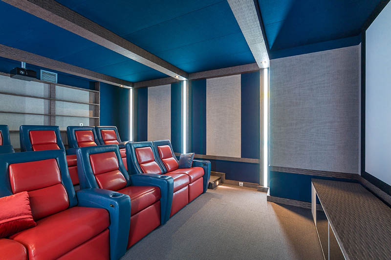 The interior of a private home theater, decorated in gray and blue