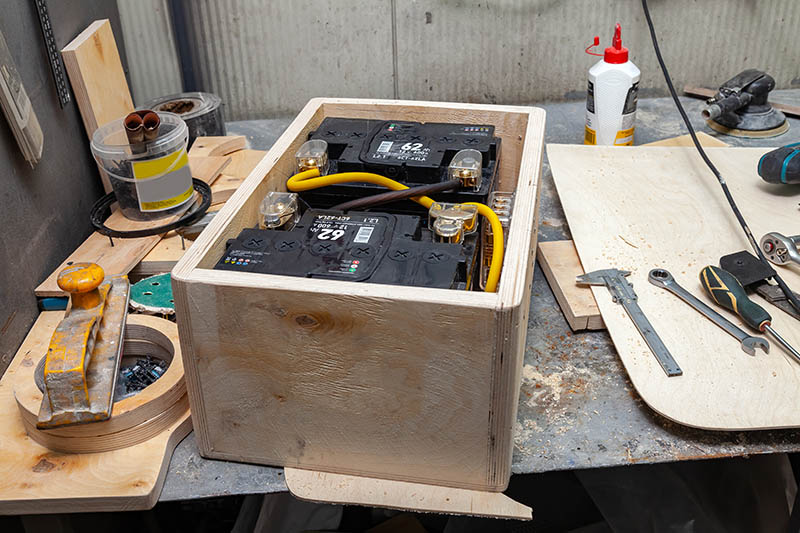 Wooden box with two car batteries