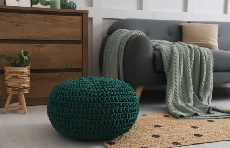 knitted pouf near sofa in living room