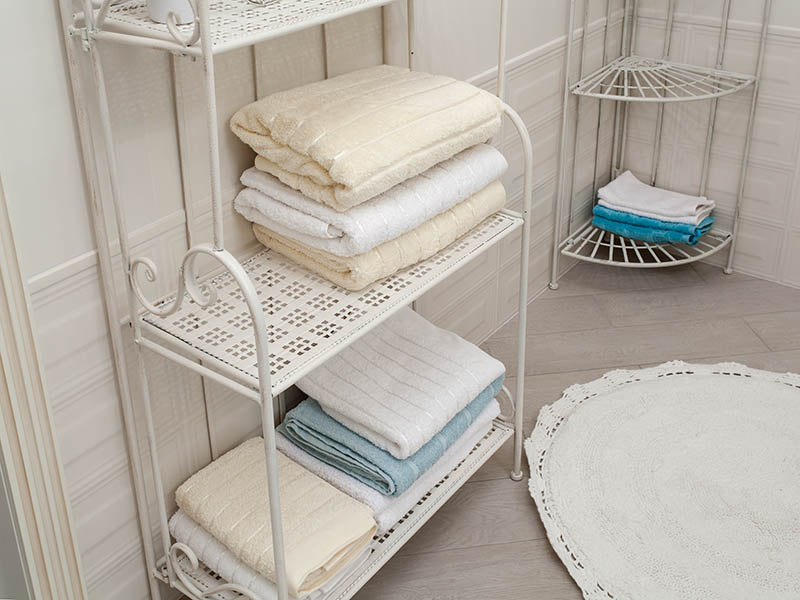 light colored bathroom towels on the iron-shod vintage shelves