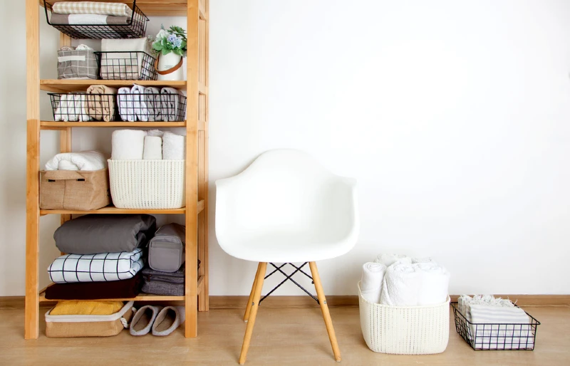 vertical storage with open shelves beside a chair