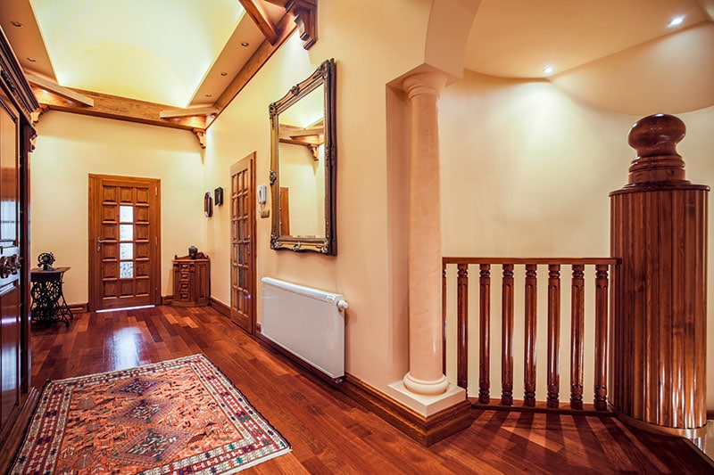 Picture of spacious hallway with wooden floor and decorative rug