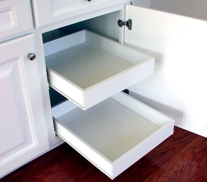 Pull out shelf drawers on white laminated cabinets in a contemporary American house kitchen