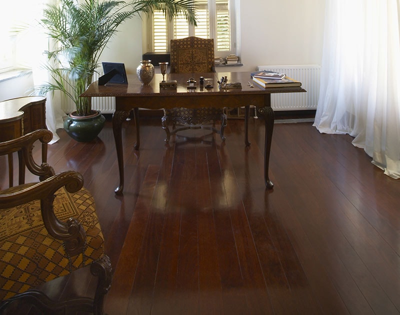 View of home office on hardwood floor in colonial style mansion