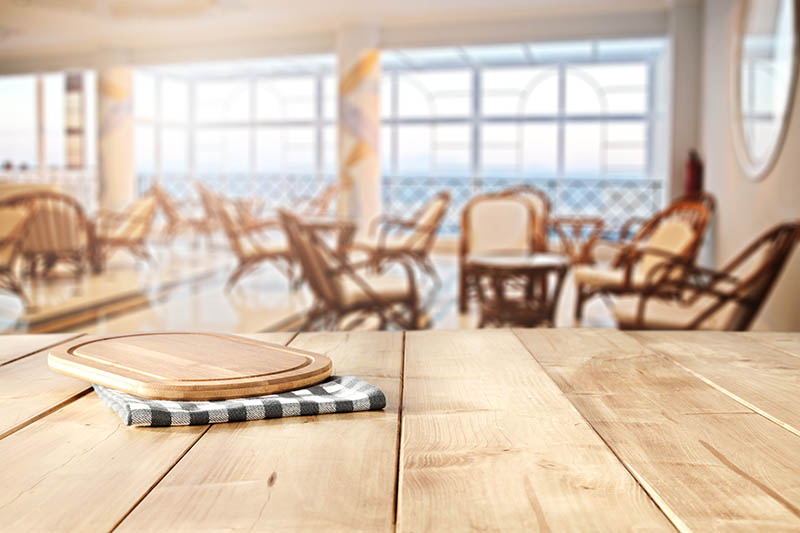 blurred background of interior and yellow table place and window